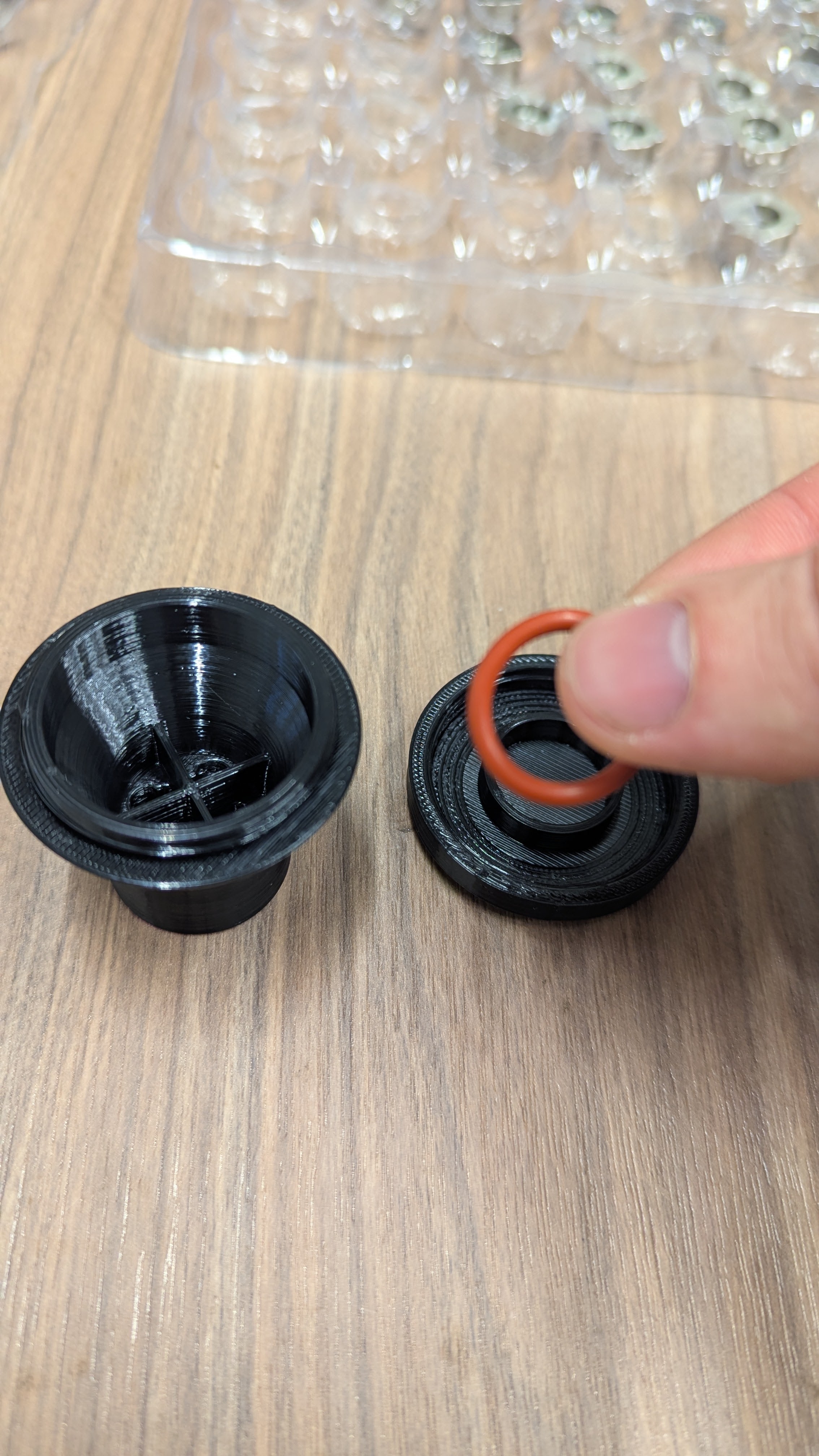 Internal compartment exposed showing spare O-ring location and removal