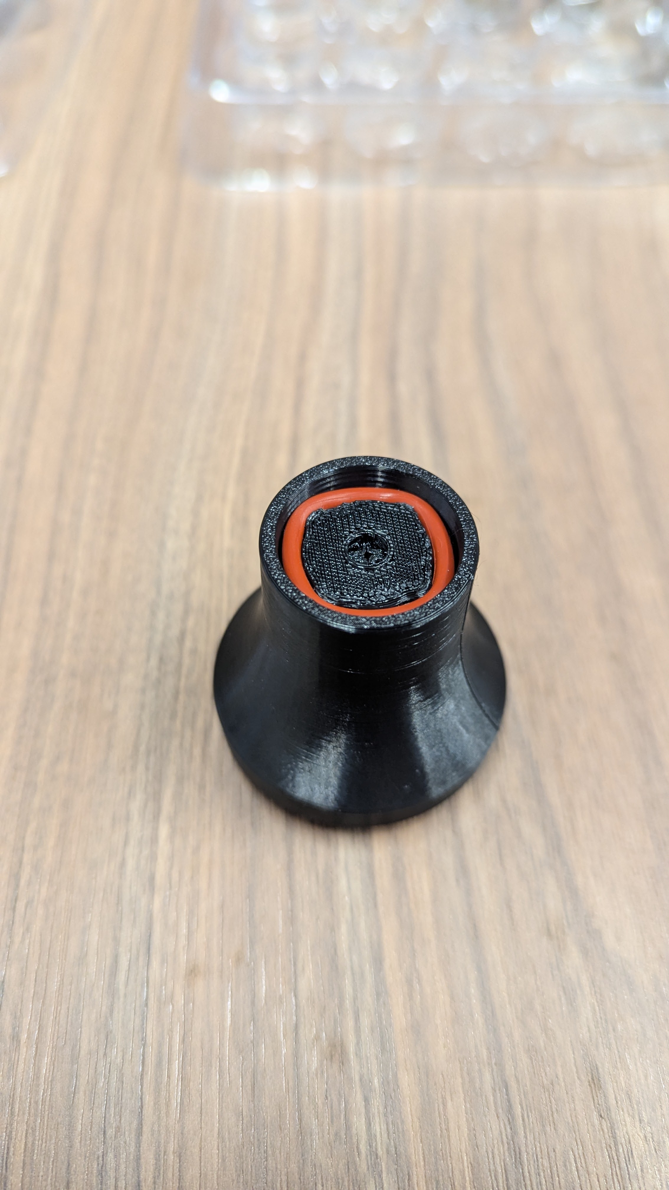 Twisting handle to stretch O-ring over the 4 tabs